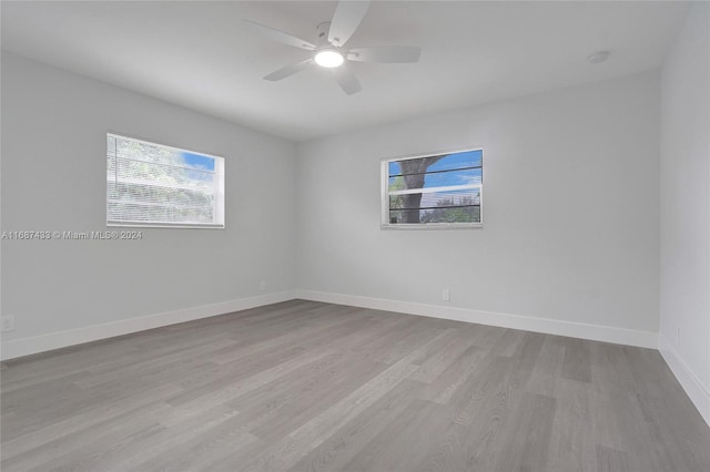 spare room with ceiling fan and light wood-type flooring