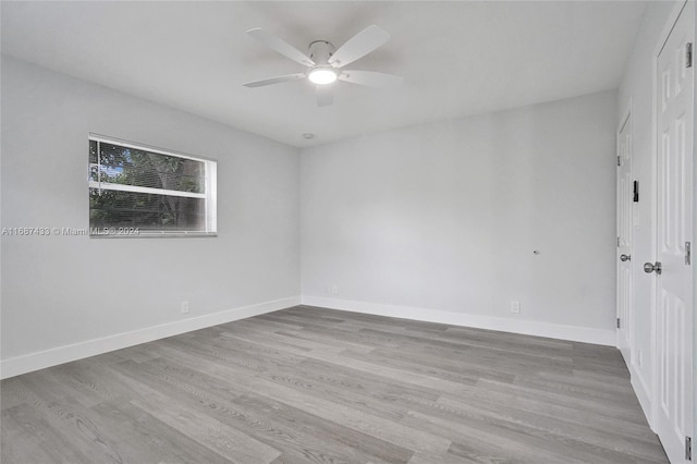 spare room featuring light hardwood / wood-style floors and ceiling fan