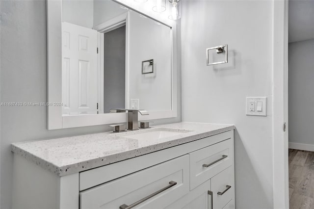 bathroom with vanity and wood-type flooring