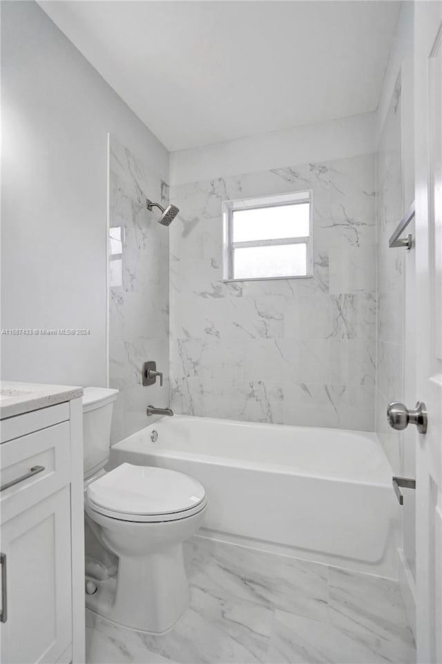 full bathroom featuring tiled shower / bath combo, toilet, and vanity