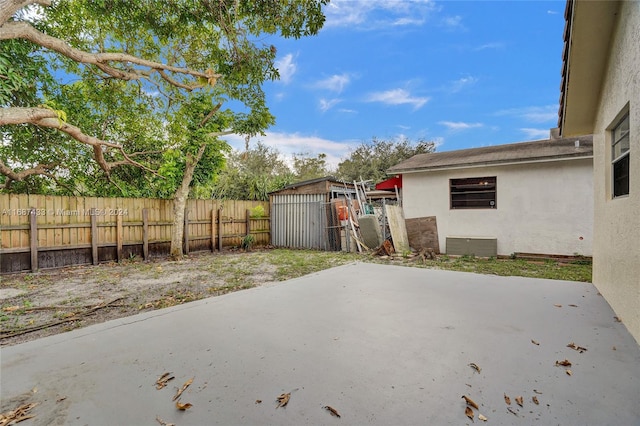 view of patio featuring a storage unit