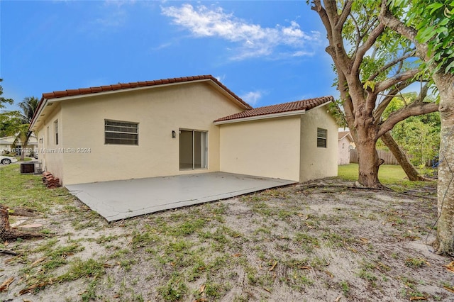 rear view of house featuring a patio and central AC