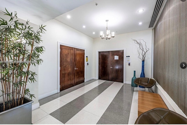 foyer featuring a chandelier