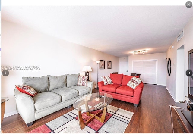 living room with dark wood-type flooring