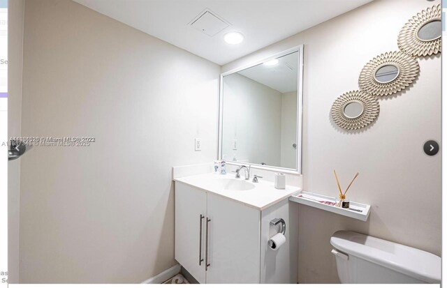 bathroom with toilet and vanity