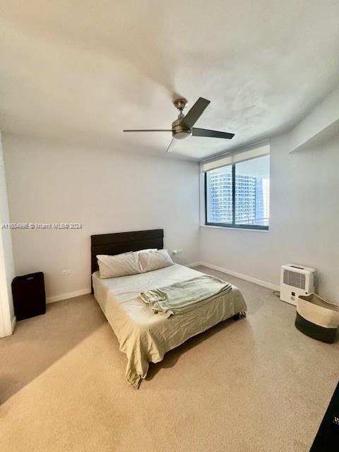 bedroom featuring ceiling fan and carpet