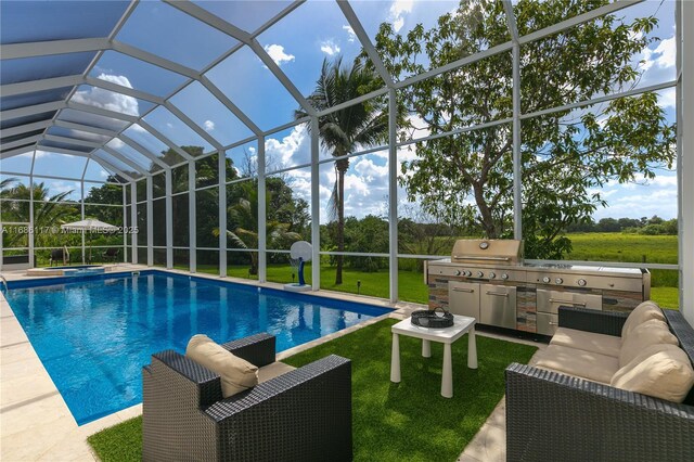 pool featuring a lanai, a patio area, an outdoor kitchen, and an in ground hot tub