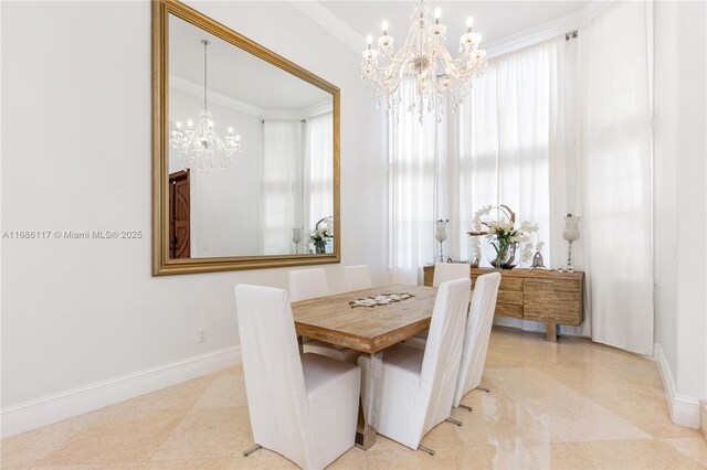 dining space featuring a chandelier, crown molding, and baseboards