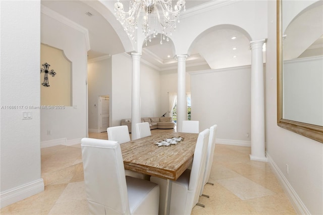 dining area featuring ornamental molding, arched walkways, baseboards, and ornate columns