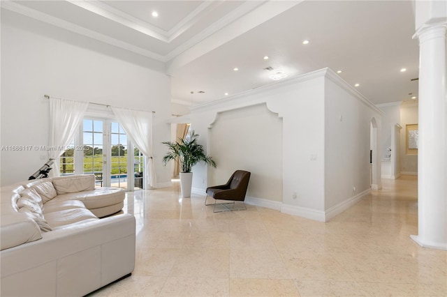 living area with decorative columns, baseboards, ornamental molding, a high ceiling, and recessed lighting