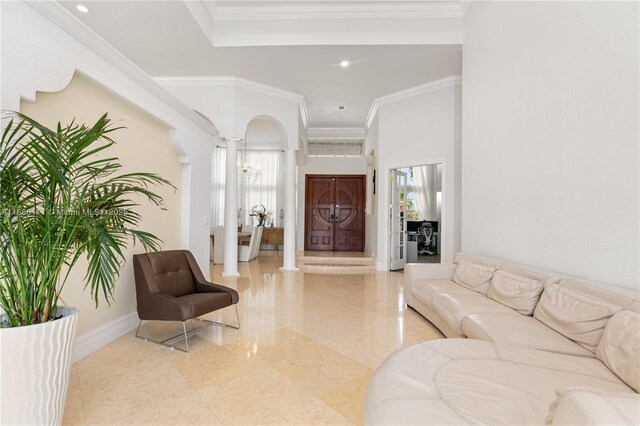 interior space with decorative columns, baseboards, arched walkways, crown molding, and recessed lighting