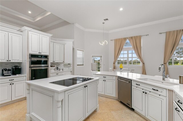 kitchen with appliances with stainless steel finishes, a sink, decorative backsplash, and ornamental molding