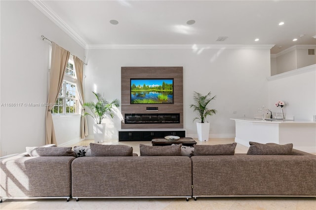 living area with ornamental molding, a glass covered fireplace, baseboards, and recessed lighting