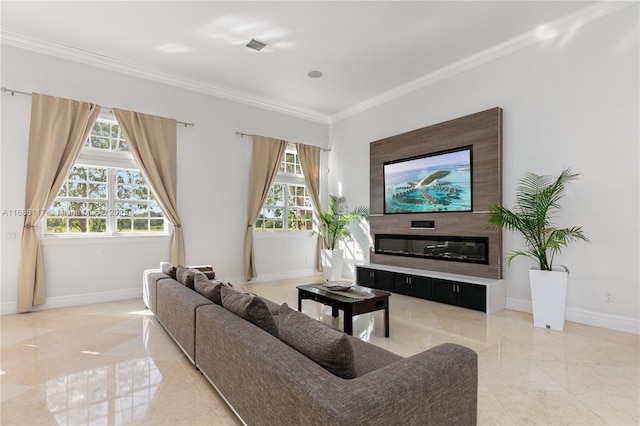 living area featuring ornamental molding, a glass covered fireplace, and baseboards