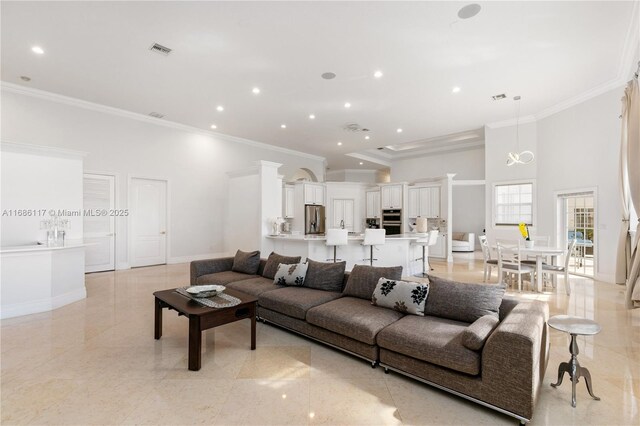 living area with recessed lighting, a high ceiling, visible vents, baseboards, and crown molding