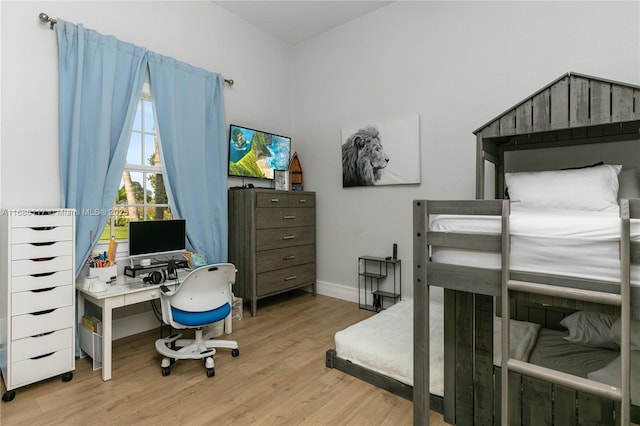 bedroom with wood finished floors and baseboards