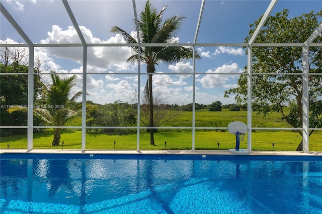 pool with a lanai and a yard