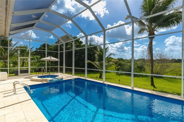 view of pool featuring a yard, a pool with connected hot tub, glass enclosure, and a patio