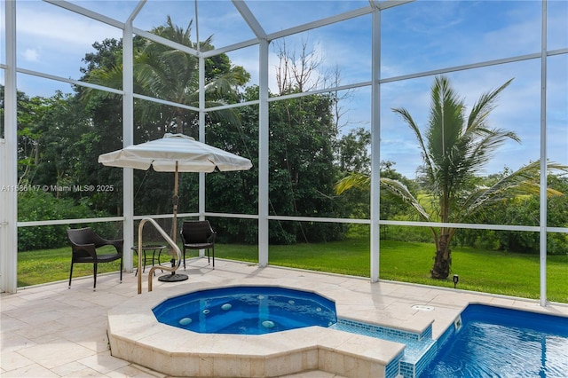 pool featuring a yard, glass enclosure, a patio area, and an in ground hot tub