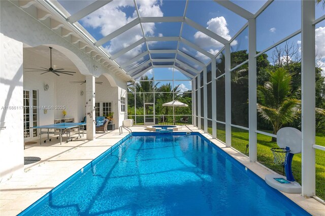 outdoor pool featuring a lanai, a patio area, ceiling fan, and an in ground hot tub