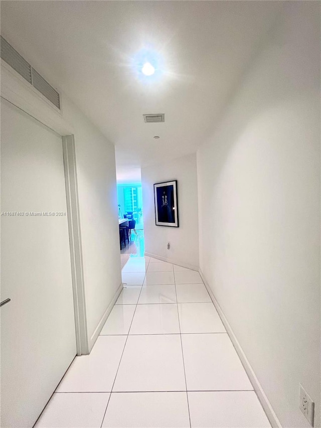 corridor featuring light tile patterned floors