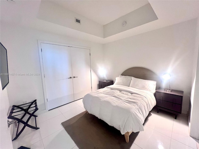 tiled bedroom featuring a closet