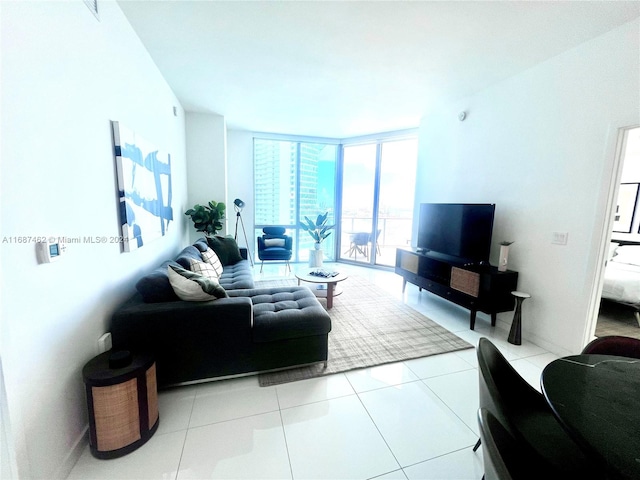 living room with a wall of windows and light tile patterned floors