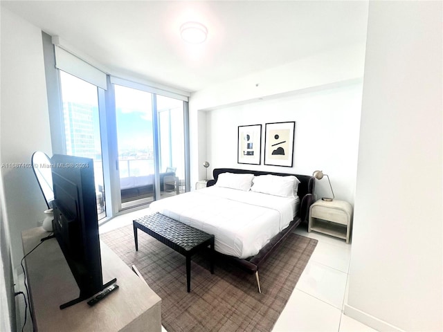 bedroom featuring light tile patterned flooring, floor to ceiling windows, and access to outside