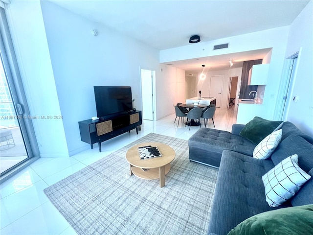 living room featuring light tile patterned flooring and sink