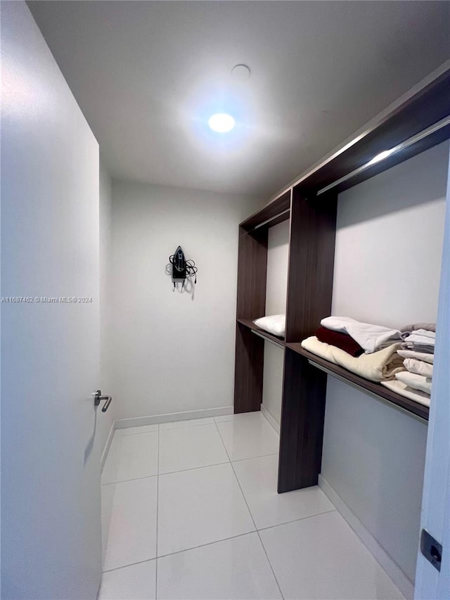 walk in closet with light tile patterned floors