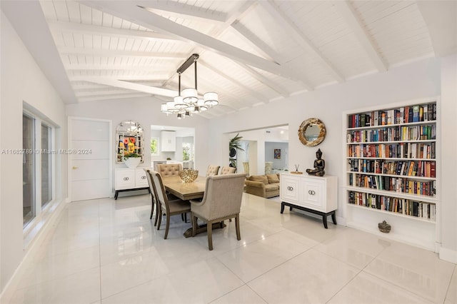 dining space with vaulted ceiling with beams, light tile patterned floors, and a chandelier