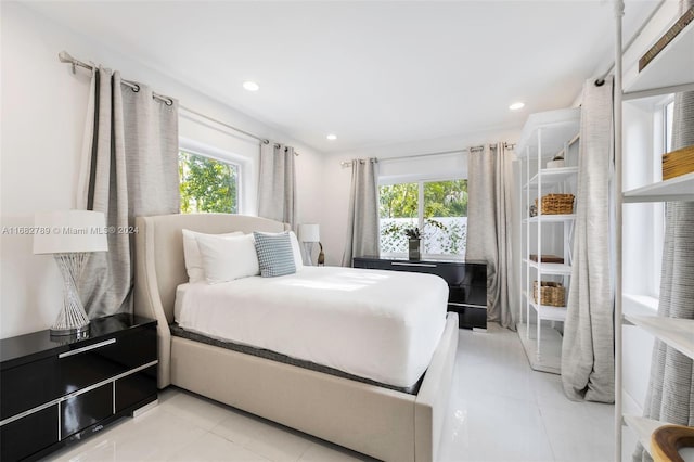 tiled bedroom with multiple windows