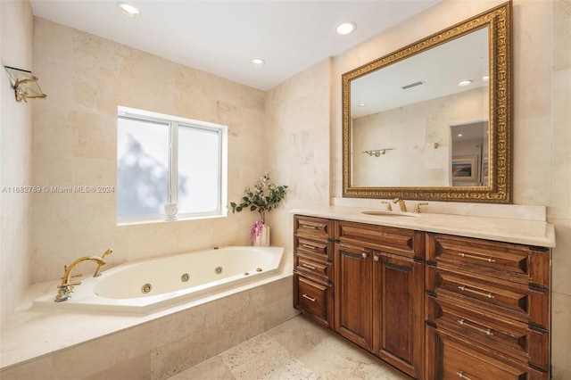 bathroom with vanity and tiled tub