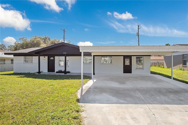 ranch-style home with a front lawn and a carport