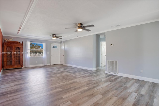 spare room with light hardwood / wood-style flooring, a textured ceiling, crown molding, and ceiling fan