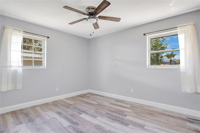 empty room featuring light hardwood / wood-style flooring, ceiling fan, and plenty of natural light