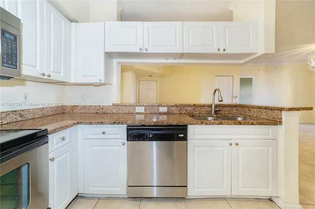 kitchen with white cabinetry, stainless steel appliances, sink, and stone countertops