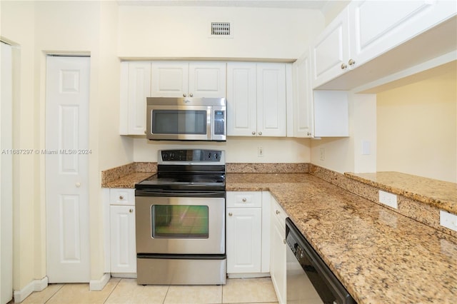 kitchen with white cabinetry, light stone countertops, appliances with stainless steel finishes, and light tile patterned floors