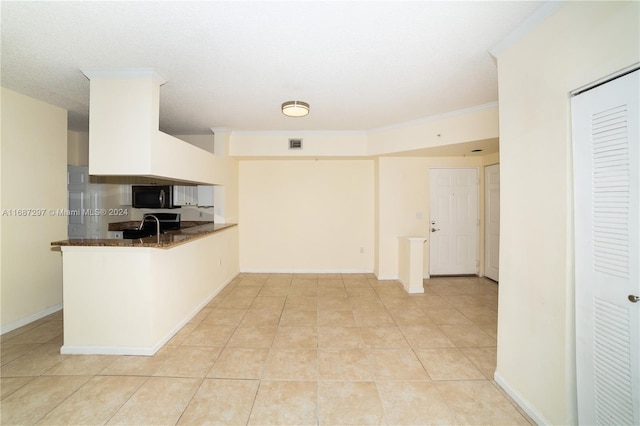 kitchen with ornamental molding, kitchen peninsula, white cabinetry, and light tile patterned flooring