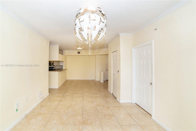 corridor featuring a notable chandelier, a textured ceiling, and light tile patterned floors