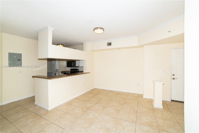 kitchen with kitchen peninsula, electric panel, black appliances, and light tile patterned floors