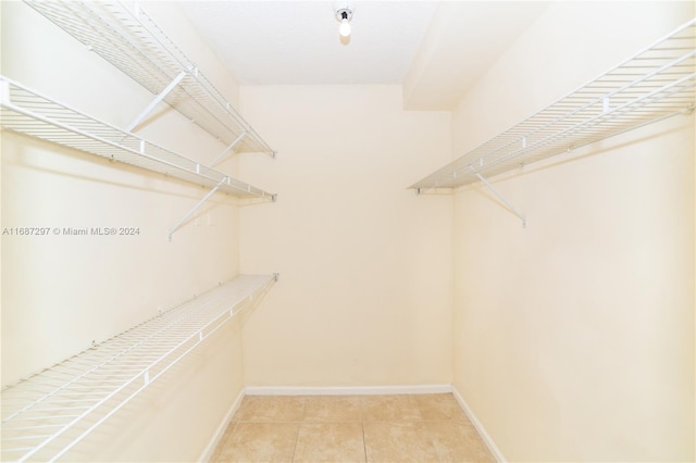 spacious closet with light tile patterned floors