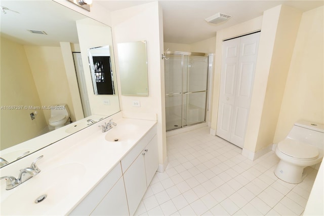 bathroom featuring vanity, toilet, walk in shower, and tile patterned flooring