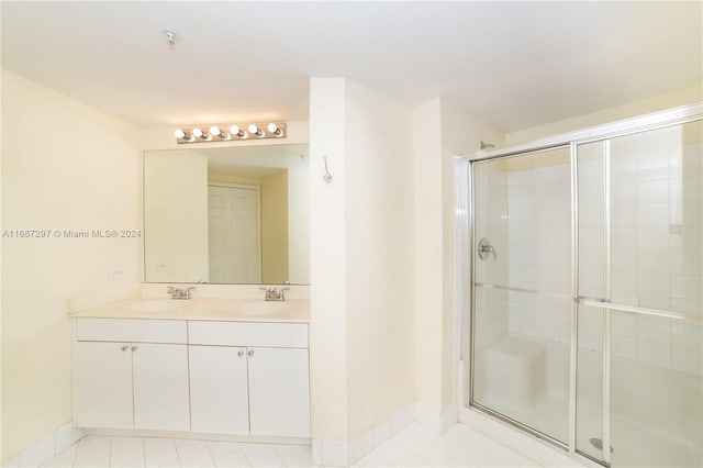 bathroom with vanity and a shower with door