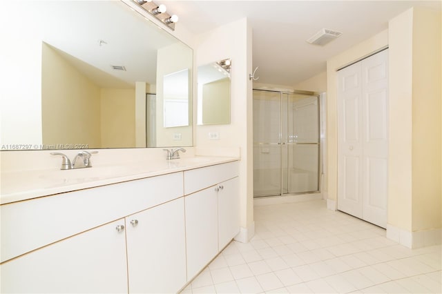 bathroom featuring vanity, tile patterned floors, and an enclosed shower