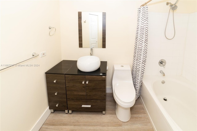 full bathroom with vanity, shower / bath combination with curtain, hardwood / wood-style flooring, and toilet