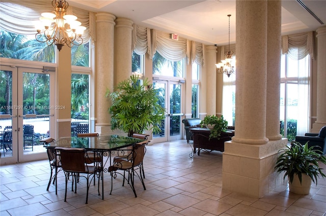 dining area featuring french doors, ornate columns, and plenty of natural light