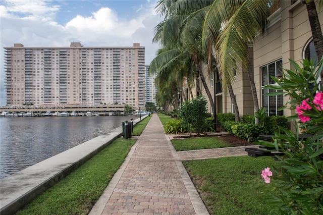 view of community featuring a water view and a lawn