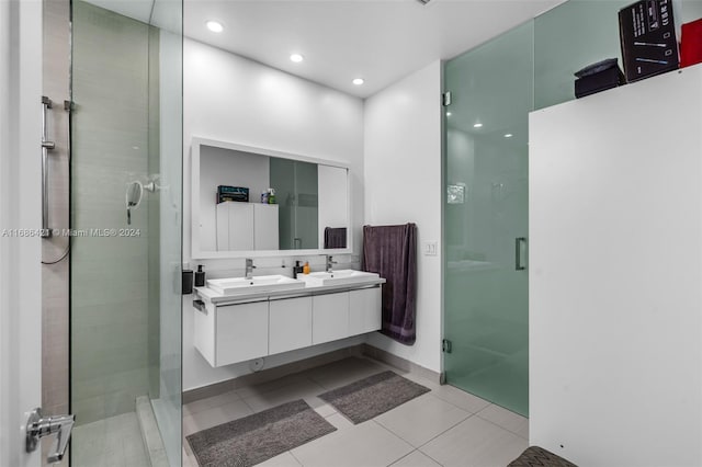 bathroom featuring vanity, tile patterned flooring, and a shower with door