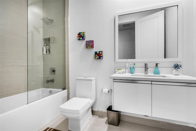 full bathroom featuring vanity, shower / bath combination with glass door, toilet, and tile patterned floors